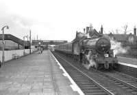 Crab 2-6-0 no 42737 stands at the up platform in Beattock station on 29 March 1964 with the SLS <I>'Scottish Rambler No 3'</I> railtour. At the other end of the train standard 2-6-4 tank 80118 is coupling up in readiness for the short trip to Moffat. [See image 30082]<br><br>[John Robin 29/03/1964]