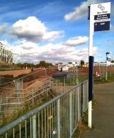 Mud, mud, glorious mud: a new railway station starts to take shape at last between Coventry's Ricoh Arena (left) and the popular Arena Retail Park (right). The steps lead down to a pedestrian underpass running below a three arch railway viaduct. View north towards Nuneaton on 19 October 2014. [See image 40050]<br><br>[Ken Strachan 19/10/2014]