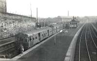 A quiet Tuesday afternoon at Springburn station on 15 November 1960, with a recently arrived electric service from Milngavie standing in bay platform 3. The North British Railway Company's Atlas Works dominates the background.  <br><br>[G H Robin collection by courtesy of the Mitchell Library, Glasgow 15/11/1960]