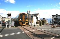 The 1259 service to Pwllheli approaches the level crossing in Criccieth on a sunny 14th October 2014.<br><br>[Colin McDonald 14/10/2014]