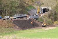 Activity around the south portal of Bowshank Tunnel on 24 October 2014 seen from alongside the A7. 'Slab track' has already been laid through the 200m tunnel (provided as 'passive provision' for possible future electrification). The double track route through the tunnel is part of a 6.4km dynamic passing loop on the new Borders Railway. [See image 49398]<br><br>[John Furnevel 24/10/2014]
