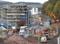 A hive of activity in Galashiels on 25 October 2014, looking north west from Station Brae road bridge. On the left construction is well advanced on the transport interchange [see image 48198], while on the other side of the A7 Ladhope Vale work is underway around the site of the new station.  <br><br>[John Furnevel 25/10/2014]
