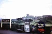 Old photograph taken in 1961 looking south east over the down platform at Criccieth station towards the ruins of Criccieth Castle (on Kodak film!) [See image 49212]<br><br>[John Thorn //1961]
