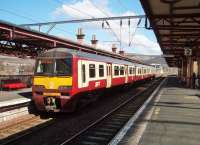 320304, in SPT carmine and cream livery, pauses at Dumbarton Central with an eastbound service in April 2008. <br><br>[Mark Bartlett 17/04/2008]