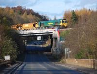 Freightliner 66610 crossing Gore Glen Bridge with a ballast train on 3 November.<br><br>[Bill Roberton 03/11/2014]