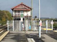 The now redundant mechanical signal box at the east end of Barry station island platform on 30 October 2014, following completion of re-signalling and transfer of control to Cardiff. The palisade fence running across the full platform in front of the box is repeated at the west end of the platform. <br><br>[David Pesterfield 30/10/2014]
