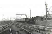 V3 67679 eastbound under the wires at Kelvinhaugh Junction on 14 July 1961. The train is about to start the descent to Finnieston [NBR] on a Dalmuir Park to Bridgeton Central service. This was the period during which steam hauled services had been hastily reinstated following temporary withdrawal of the Class 303 (originally AM3) electric units to remedy a fault with the switchgear. [See image 49348] <br><br>[G H Robin collection by courtesy of the Mitchell Library, Glasgow 14/07/1961]