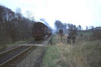 The last vestiges of early morning mist hang around Thorntonhall Lane crossing in April 1966 as an East Kilbride - Glasgow train approaches. This was the final week of steam hauled services on the line.<br><br>[John Robin /04/1966]