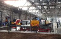 Contrast in noses at Glasgow Central on 10 November 2014. The 11.00 CrossCountry Voyager for Penzance waits to leave platform 1, while a Class 37 on Network Rail duties stands at platform 2.<br><br>[Colin Miller 10/11/2014]
