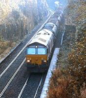 A pair of class 66 locomotives with a ballast train on the Edinburgh <I>sub</I> on a bright Sunday morning in October 2003. The train is about to pass north through the abandoned platforms of the former Craiglockhart station with EWS 66050 leading.<br><br>[John Furnevel 06/10/2003]