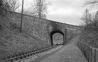 Old undated photograph looking along the Peebles Loop towards Clovenfords at Balnakeil, showing the highly skewed arch (Bridge No. 65) that carried the A72 road over the Peebles branch on the western outskirts of Galashiels. If this view was still possible today (2014), Bruce Motors garage would be visible through the bridge.<br><br>[Bill Jamieson Collection //]