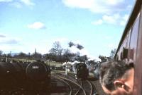 A busy scene at the north end of Dumfries on 15 April 1963. Photograph taken from a window of <I>Scottish Rambler No 2</I> which is waiting to enter the station off the Lockerbie branch behind Jubilee 45588 <I>Kashmir</I>. The hold up is to allow the passage of a London relief, approaching the station in the background behind another Jubilee 45659 <I>Drake</I>. Standing alongside the special is 78026, the Dumfries station pilot.<br><br>[John Robin 15/04/1963]