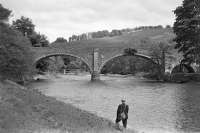 Old photograph looking north east at Ettrickfoot featuring the bridge which used to carry the A7 over the River Tweed just upstream of its confluence with the Ettrick Water. The bridge carrying the Selkirk branch over the combined waters of the Tweed and Ettrick can be seen through the left-hand arch. [Ref query 9279]<br><br>[Bill Jamieson Collection //]