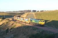 An empty ballast train consisting of 30 vehicles trundles back to base over Falahill at around 2.30pm on 2 December 2014. Freightliner 66605 was on the north end of the train with 66603 bringing up the rear.<br><br>[Bruce McCartney 02/12/2014]