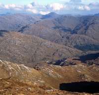 View from near the summit of Beinn Odhar Mhor, on the west side of Loch Shiel on 14 October 2014. The prominent hill in the background is the Munro Sgurr nan Coireachan with the Corbett Sgurr an Utha in front of it. The exhaust trail just visible lower centre is from Black 5 45407 heading for Mallaig with <I>The Jacobite</i>.<br><br>[Bill Jamieson 14/10/2014]