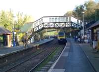 Arrival of the 11.47 to Penzance at Bodmin Parkway on 29 November 2014 - a large train for a small station; which, commendably, has an hourly bus to Padstow, some 50 years after the latter station closed. The lie of the land, and the use of the up platform for Bodmin and Wenford trains, reminds me of Norchard in the Forest of Dean [see image 31050]. The signal box just visible on the right is now used as a cafe.<br><br>[Ken Strachan 29/11/2014]