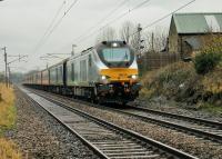 The <I>Yuletide Yorkshire Explorer</I> ran from Newport in South Wales to Leeds on 6th December. The train was hauled throughout by Chiltern Class 68 68014 and took a circuitous route round Birmingham and Manchester. It is seen here heading north at Woodacre prior to taking the Carnforth to Skipton route. Note the small headboard above the right buffer. <br><br>[Mark Bartlett 06/12/2014]