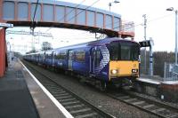 318257 coupled to 320313 arriving at Mount Vernon from Motherwell on Sunday 14th December 2014, the first day of the new electric services on the Whifflet line.<br><br>[Colin McDonald 14/12/2014]
