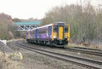 A 156/142 combination, forming a Northern service to Southport, are signalled for the Westhoughton and Wigan line at Lostock Junction. The large steel bridge in the background carries the A58 Bolton ring road over the line from Bolton. <br><br>[Mark Bartlett 02/12/2014]