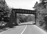 This undistinguished plate girder bridge shows the crossing of the A7 road by the Selkirk branch near the entrance to Bridgeheugh Farm. The undated photograph has been taken looking north towards Galashiels.<br><br>[Bill Jamieson Collection //]