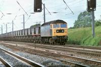 Brush Type 4 47340 hauls a loaded MGR train southwards on the Up Fast line between Farington Junction and Leyland in June 1981. Taken into service in 1965 as D1821 the loco was withdrawn in 1998 and cut up at Crewe Works. <br><br>[Mark Bartlett 10/06/1981]
