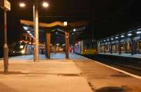 Evening scene at Preston station on 20 December 2014. On the right 142045 awaits departure time at platform 3C with the 2205 service to Ormskirk. On the left is the terminating 1P06 from Euston which is preparing to run as 5H06 to Longsight<br><br>[John McIntyre 20/12/2014]