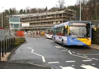 The 61 service to Earlston is amongst the buses using temporary stops in Stirling Street, Galashiels, on 26 December 2014, while construction work on the new transport interchange continues in the background.  <br><br>[John Furnevel 26/12/2014]