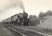 42275 approaching Williamwood from the Muirend direction in June 1955 with a train for Uplawmoor. The embankment on the right carried the line from Muirend to Clarkston East Junction and was used from time to time for the storage of carriages and wagons awaiting repair or scrapping. [See image 9185] <br><br>[G H Robin collection by courtesy of the Mitchell Library, Glasgow 18/06/1955]