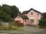 The distinctly pink station building at Little Eaton alongside the surviving railway bridge, seen in September 2014. Thought to be the former station master's house. [See image 48811]<br><br>[Ken Strachan 13/09/2014]