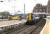 Plenty of colour at Ayr station on 31 October. Colas Rail Freight 56302 has just run round the Prestwick Airport aviation fuel tanks in Platform 3, while the 11.36 to Glasgow Central stands at Platform 2.<br><br>[Colin Miller 31/10/2014]