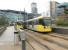 In the shadow of the BBC and ITV studios, Metrolink trams 3089 and 3087, both engaged on services to and from Eccles, pass at Media City on Sunday 16 November. Trams reverse here to rejoin the Eccles line proper and continue their journeys. Monday to Saturday this terminus of a very short branch is served by shuttle services from Piccadilly.  <br><br>[Mark Bartlett 16/11/2014]