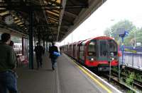 Central line terminus at Ealing Broadway in the summer of 2005. Looking east from the concourse, with a Hainhault train awaiting its departure time at platform 5.<br><br>[John Furnevel 20/07/2005]