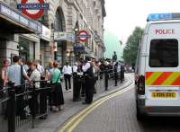Heavy police presence in and around Baker Street Underground station on Friday 22 July 2005, the day after the failed London bombing attempts. Meanwhile the tall gentleman standing in the background outside number 221b puffs on his pipe and quietly ponders the situation.<br><br>[John Furnevel 22/07/2005]