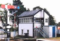 The signal box at Kingussie in 2001, looking east from the down platform with the B970 level crossing beyond.<br><br>[John Furnevel 15/09/2001]