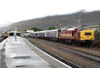 37406 <I>The Saltire Society</I> with the sleeper in the service siding at Fort William station under low clouds in September 2005. A service to Mallaig is preparing to leave platform 2.<br><br>[John Furnevel 27/09/2005]