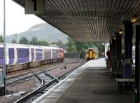 <h4><a href='/locations/F/Fort_William'>Fort William</a></h4><p><small><a href='/companies/W/West_Highland_Railway'>West Highland Railway</a></small></p><p>A train for Glasgow Queen Street leaving platform 1 at Fort William on 27 September 2005. The train is passing the stock of the London sleeper stabled in the service siding. 13/42</p><p>27/09/2005<br><small><a href='/contributors/John_Furnevel'>John Furnevel</a></small></p>