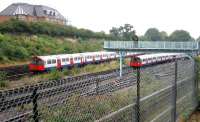 Eastbound Piccadilly line tube trains from Heathrow (left) and Rayners Lane meet just west of Acton Town station on 21 July 2005.<br><br>[John Furnevel 21/07/2005]