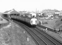 A Glasgow Central - Ayr train passing Ayr MPD and about to run through Hawkhill Junction in April 1975. Note the unidentified EE Type 4 on the right waiting with a train on the spur between Blackhouse and Hawkhill Junctions.<br><br>[John Furnevel 04/04/1975]