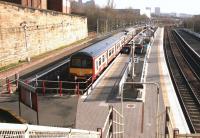 Looking south from the station footbridge at Springburn on 14 February 2005 with a train for Dalmuir awaiting its departure time in platform 3.<br><br>[John Furnevel 14/02/2005]