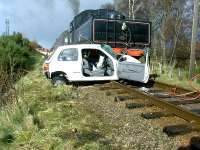 A graphic illustration of what can happen when you ignore the warning lights at an ungated level crossing. This is Dalfaber on the Strathspey Railway where, fortunately, only the car was written off. Photo credit David Gray.<br><br>[John Gray 06/04/2005]