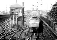 Scene at Dundee in September 1980 as a class 47 arrives with a Glasgow - Aberdeen train past Dundee West signal box.<br><br>[John Furnevel 22/09/1980]