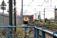 A Virgin Trains Manchester - Birmingham - Brighton service crosses the Grand Union Canal via Mitre Bridge on the West London Line in July 2005. The train has travelled from Birmingham via Oxford, Reading and the Great Western main line, and reached the southbound West London Line via Acton East Junction, Acton Wells Junction, West London Junction and Mitre Bridge Junction. Who needs railtours? <br><br>[John Furnevel 22/07/2005]