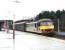 A lengthy train of wet containers speeds south through a wet Carstairs past a wet photographer on a wet December day in 2004. The wet locomotive is Freightliner 90049.<br><br>[John Furnevel 02/12/2004]