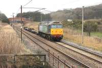 <I>Diesel locomotive - trailing load 1215 tons</I>, or so the timetable said but DRS 57002 is hauling considerably less than that on this special working from the DRS Motherwell depot to Crewe (LNWR). The loco and its two pairs of container wagons are seen approaching Woodacre on 19th January 2015 <br><br>[Mark Bartlett 19/01/2015]