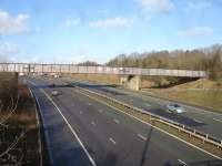 This lengthy three section steel rail over-bridge crosses both carriageways and two slip roads of the M1 motorway and carries the line between Dodworth and Barnsley stations. View north from the M1 Junction 37 / A628 interchange roundabout in January 2015.<br><br>[David Pesterfield 28/01/2015]