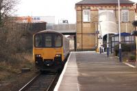 In preparation for electrification to Blackpool North, various overbridges along the route are being raised. These include the bridge at Kirkham, seen here on 2 February 2015 as a Northern service to Blackpool North arrives at the platform.<br><br>[John McIntyre 02/02/2015]