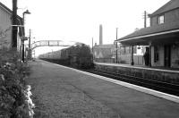 An up fast service running north through Glengarnock station in fading light on a July evening in 1963.<br><br>[Colin Miller /07/1963]
