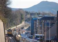 Freightliner 66619 running south light engine towards Tweedbank on 10 February 2015, passing the new Galashiels station site on Ladhope Vale. Eildon Middle Hill stands in the background.<br><br>[Bill Roberton 10/02/2015]