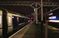The Lowland Caledonian Sleeper headed by the 90029 in fresh DB Schenker red livery waits for the off at Euston platform 15 on 10 February.<br><br>[Colin McDonald 10/02/2015]