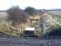 View east over the stub of the former Roslin branch looking towards the south end of Millerhill yard on 1 March 2015. The line closed following the last train from Bilston Glen Colliery in 1991 and the trackbed has now been severed by the new Borders Railway which runs north-south directly behind the camera. The recent addition in the foreground looks like an old chest freezer (?)... or possibly redundant point heating apparatus?<br><br>[Ewan Crawford 01/03/2015]
